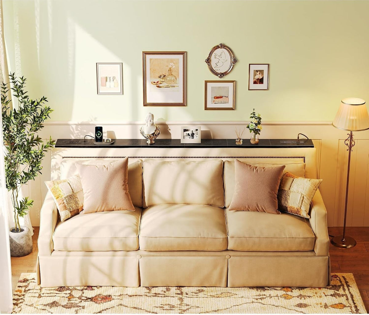 Black narrow console table with built-in outlets behind a cream sofa in a bright living room