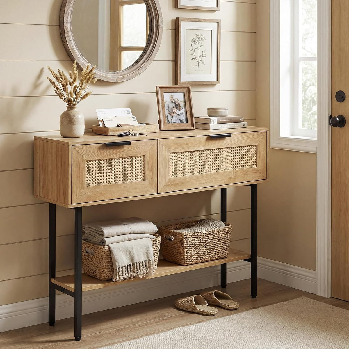 Lara rattan console table styled in an entryway with baskets on the lower shelf